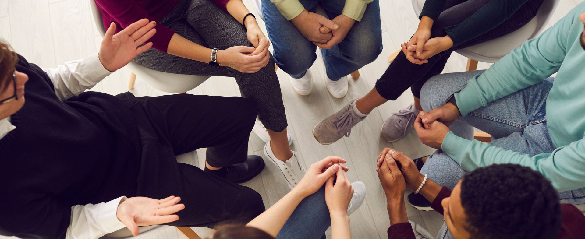 overhead view of recovery group meeting with members sitting in a circle